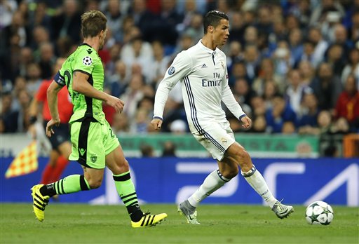 Real Madrid's Cristiano Ronaldo fights for the ball against Sporting's Adrien Silva during a Champions League, Group F soccer match between Real Madrid and Sporting, at the Santiago Bernabeu stadium in Madrid, Spain, Wednesday, Sept. 14, 2016. (AP Photo/Paul White)