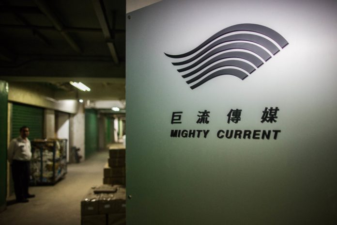 A building security guard (L) stands near the entrance to the warehouse of Hong Kong-based publisher Mighty Current in Hong Kong on January 2, 2016. A missing Hong Kong employee from a publisher of books critical of China was "assisting in an investigation", his wife said on January 2, as the city's deputy leader sought to reassure residents over their safety. AFP PHOTO / ANTHONY WALLACE