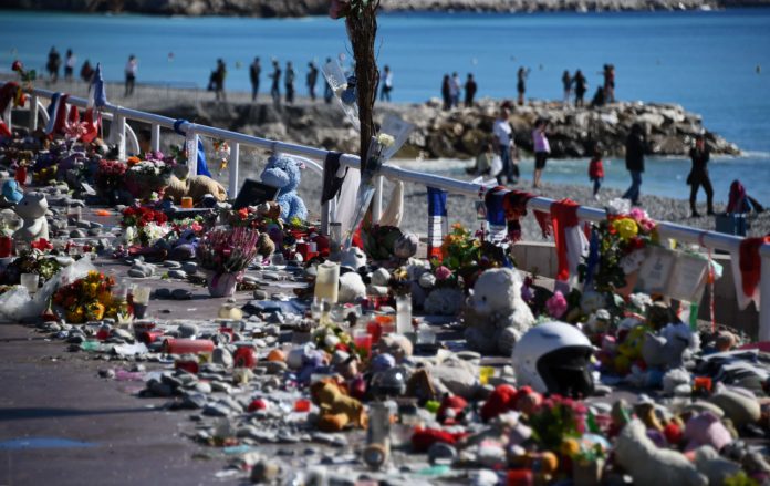 Candles, toys and flowers placed in commemoration to victims are pictured at the Boulevard des Anglais in Nice, southeastern France, on October 15, 2016, on the occasion of a national tribute to the victims of the July 14 terror attack in which a truck ploughed into crowds celebrating Bastille Day, killing 86 people and injuring more than 400. In the attack, a 31-year-old Tunisian extremist rammed a 19-ton truck through a crowd of more than 30,000 Bastille Day revellers on the seafront Promenade des Anglais before police shot him dead. The Islamic State (IS) group said the driver of the truck, Mohamed Lahouaiej Bouhlel, was one of its followers. / AFP PHOTO / ANNE-CHRISTINE POUJOULAT
