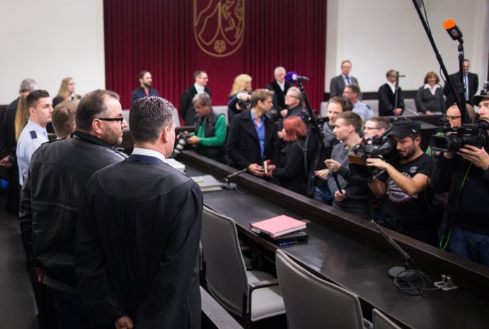 Defendant Wilfried W (L) stands next to his lawyer Detlev Binder in the courtroom of the regional court in Paderborn, western Germnay, on October 26, 2016. The trial of a man and his ex-wife accused of kidnapping and mistreating eight women, two of them to death at their home in western Germany, opened in Paderborn. / AFP PHOTO / dpa / Marcel Kusch / Germany OUT