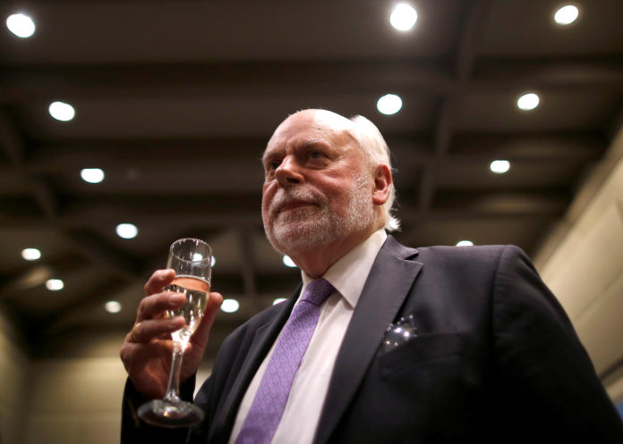 J. Fraser Stoddart, one of the winners of 2016 Nobel Prize for Chemistry, holds a glass of champagne after a news conference at Northwestern University in the Chicago suburb of Evanston, Illinois, U.S., October 5, 2016. REUTERS/Jim Young