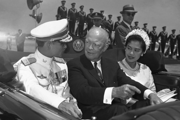 FILE - In this June 28, 1960, file photo, U.S. President Dwight Eisenhower, center, is seated between Thailand's King Bhumibol Adulyadej, left, and Queen Sirikit for a motorcade drive from National Airport to the White House in Washington. (AP Photo, File)