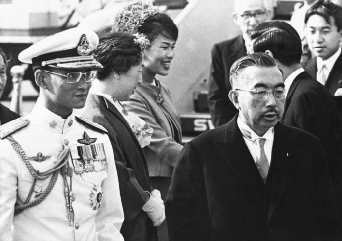 FILE - In this May 27, 1963, file photo, Japan's Emperor Hirohito, right, walks with Thailand's King Bhumibol Adulyadej, as he arrives in Tokyo. At rear are Thailand's Queen Sirikit, third from left, and Japan Empress Nagako, second left. (AP Photo, File)