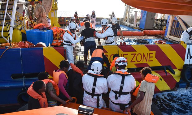 People are helped into a small rescue boat in the Mediterranean Sea off Libya. Photograph: Andreas Solaro/AFP/Getty Images