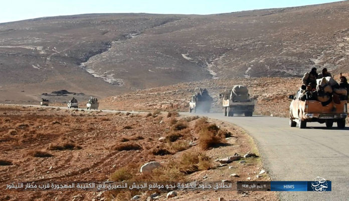 This image posted online on Saturday, Dec. 10, 2016, by supporters of the Islamic State militant group on an anonymous photo sharing website, purports to show a convoy of vehicles of IS driving in a desert area of east of Palmyra city, in Homs, Syria. Syrian opposition activists say the Islamic State group has regained control of the ancient town of Palmyra despite a wave of Russian airstrikes in a major advance after a year of setbacks for the group in Syria and Iraq. The Arabic caption reads, "Islamic Caliphate soldiers head to the bases of the Nussayari (derogative for Alawite Syrian) in the deserted base near T-4 military air base." (Militant Photo via AP)