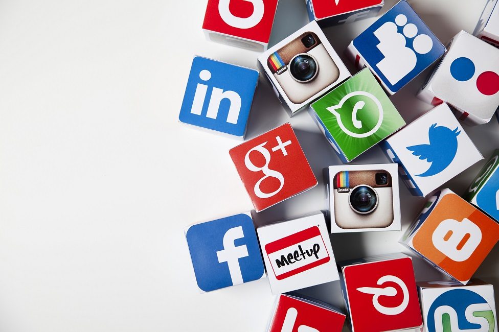 Social media logos printed onto handmade cubes. photographed in a studio.