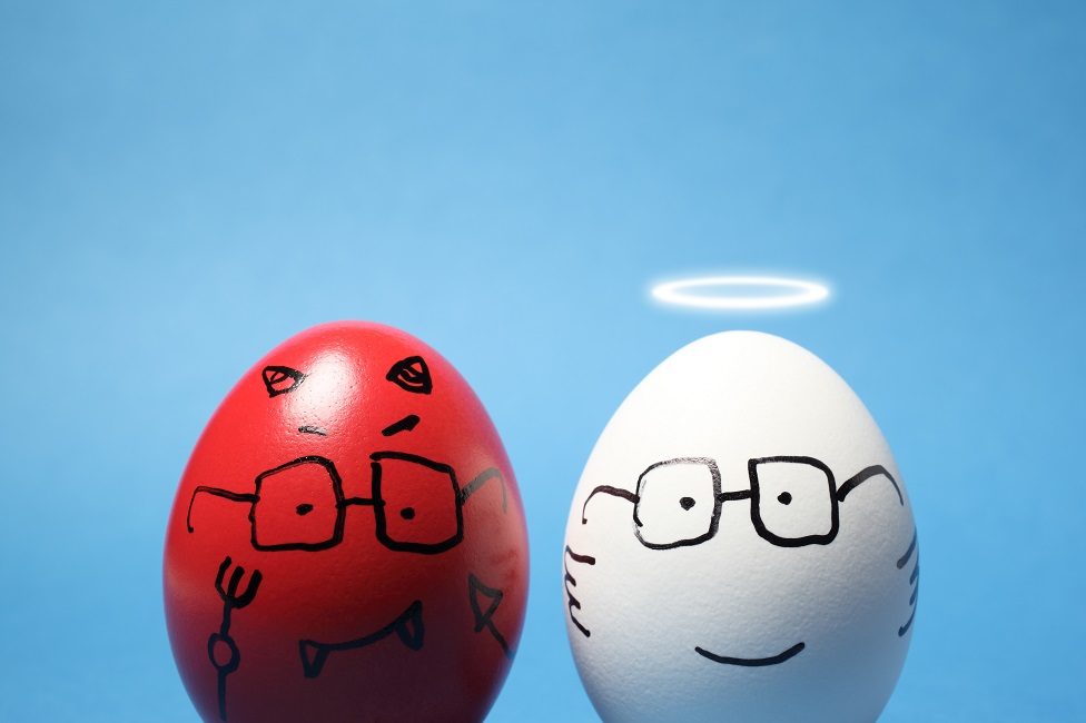 Close-up of "evil" and "angel" eggs, against blue background.