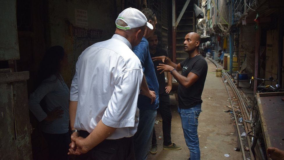 Krishna Pujari, co-founder of Reality Tour & Travel, takes aroud a group of tourists in the Dhavari slum