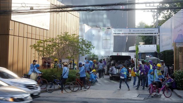 Construction workers gather in front of a construction site after tremors from a 6.1 magnitude earthquake, which hit northern Thailand, were felt, in Bangkok, Thailand, 21 November 2019