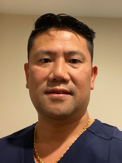 Dr Edward Chew wearing his blue medical shirt