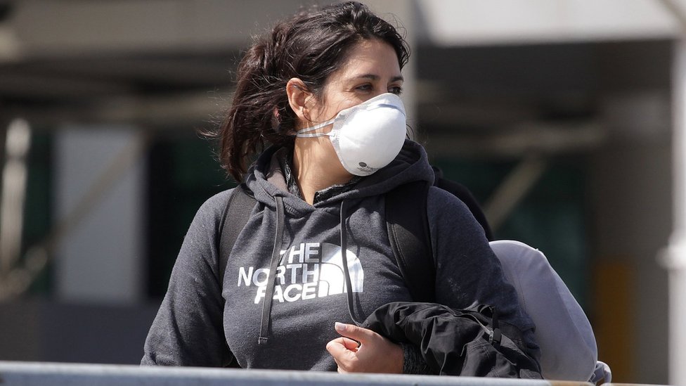 A woman wearing a mask