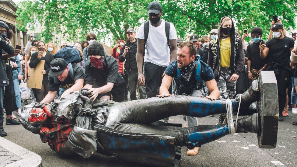 Protesters moving the statue of Edward Colston towards the river Avon