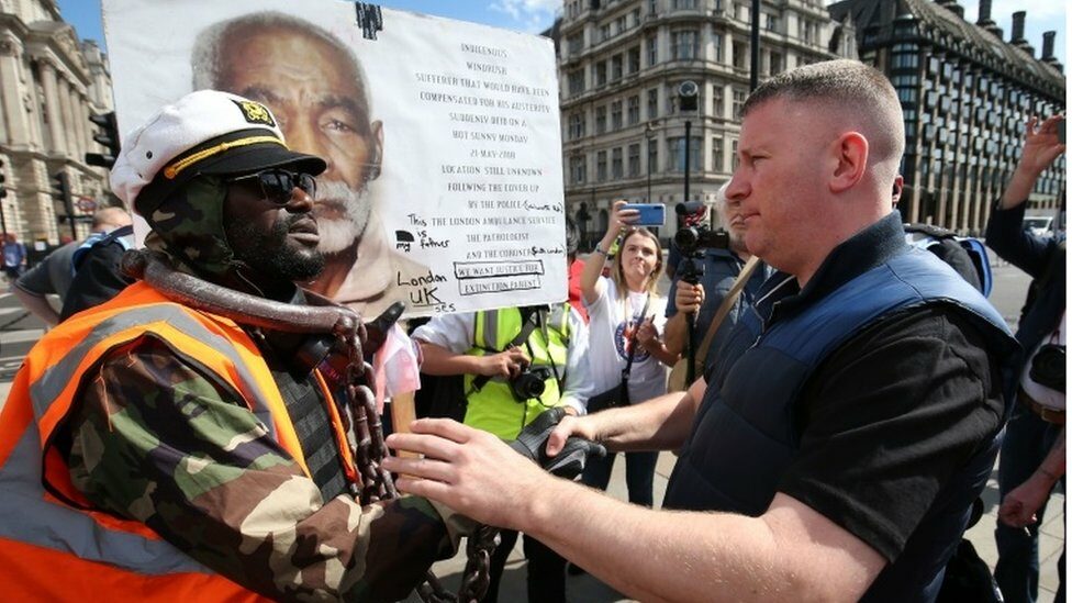 Britain First leader Paul Golding (right) shakes hands with a protester in Parliament Square, London before a possible protest by the Democratic Football Lads Alliance against a Black Lives Matter protest.