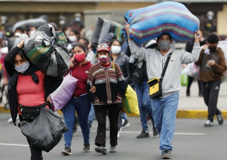 Street vendors move after being evicted by the Police from a public street where they sell their products, in downtown Lima, Peru, 12 June 2020