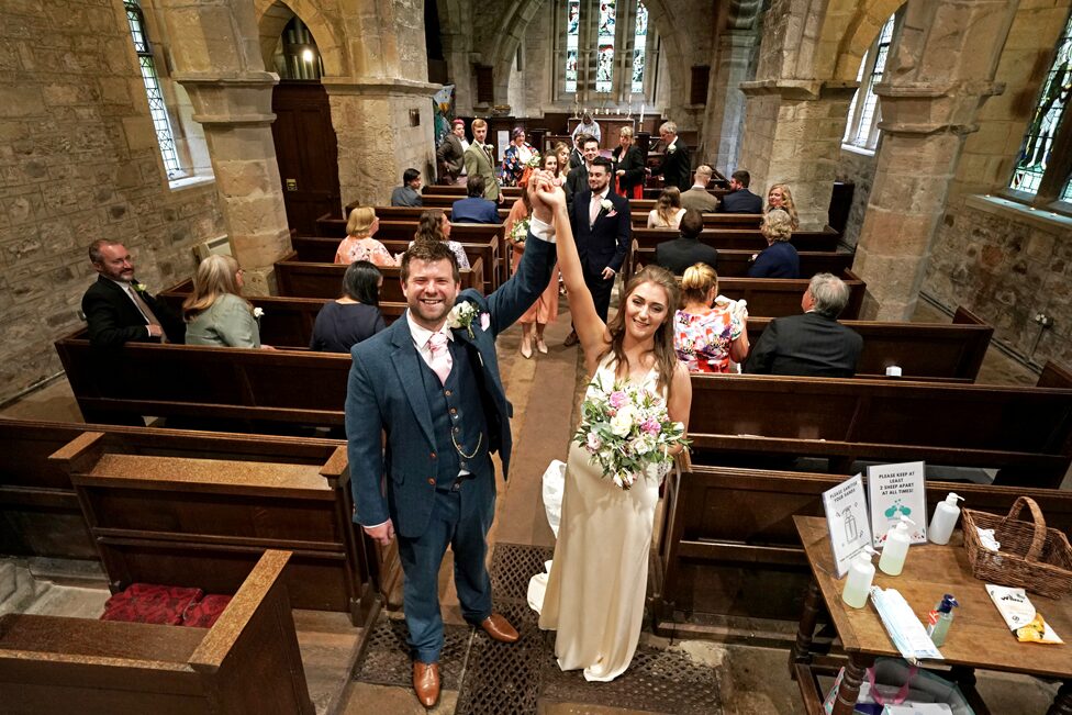 The newly married Mr and Mrs Bone, Lucy and James, pose after their wedding at St Michael and all Angels Church in Ingram, Northumberland
