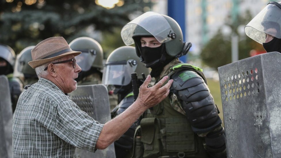 A man speaks with Belarus military special forces during a protest after the presidential election, in Minsk, Belarus, 11 August 2020