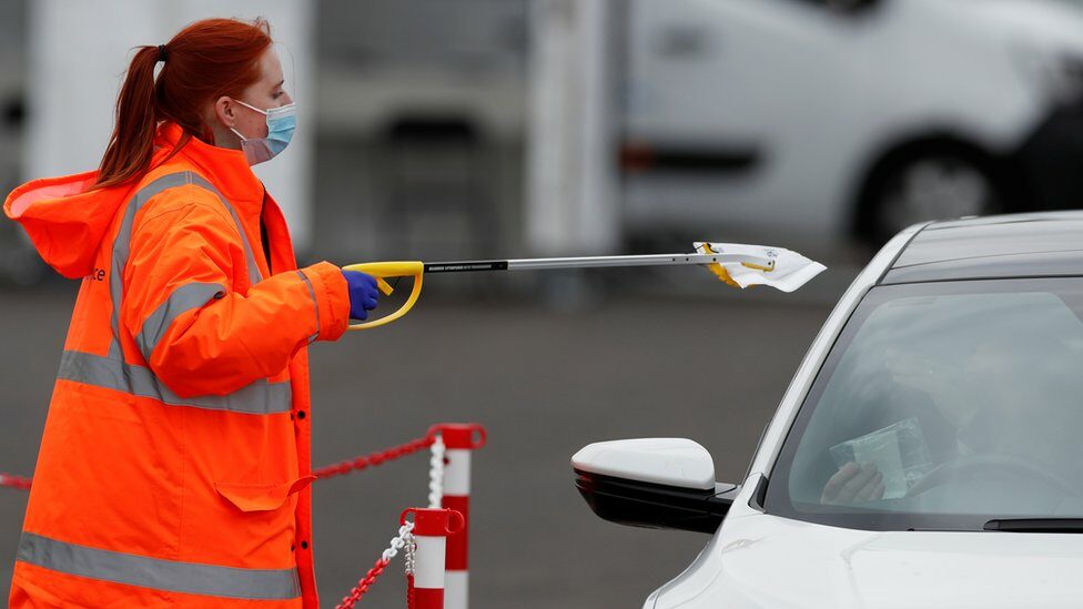 A woman collecting a PCR test in Bedford