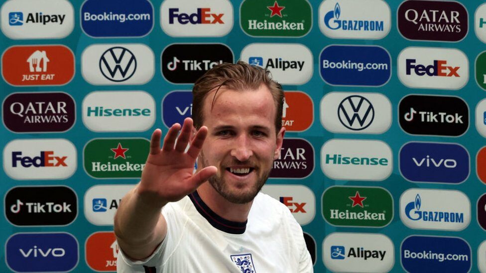 Harry Kane and sponsor logos