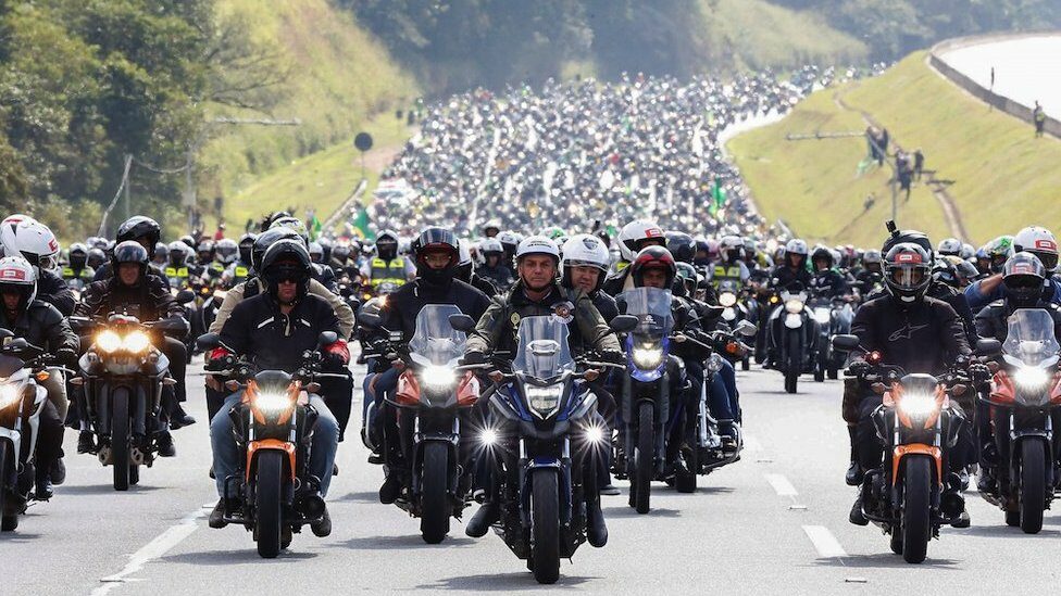 A handout photo made available by the Presidency of Brazil that shows the Brazilian President, Jair Bolsonaro (C), during a motorcycle tour with his followers, in Sao Paulo, Brazil, 12 June 2021.