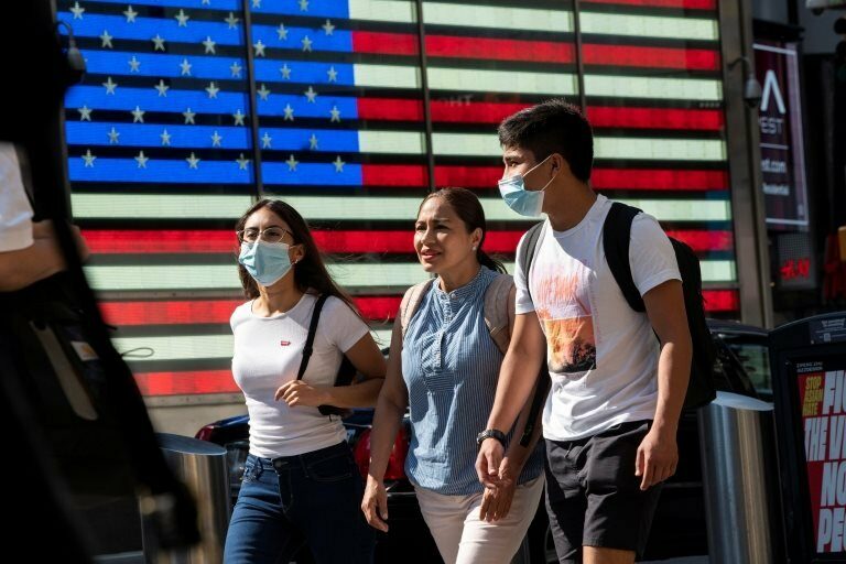 People wear masks around Times Square, as cases of the infectious coronavirus Delta variant continue to rise in New York City, New York, U.S., July 23, 2021.