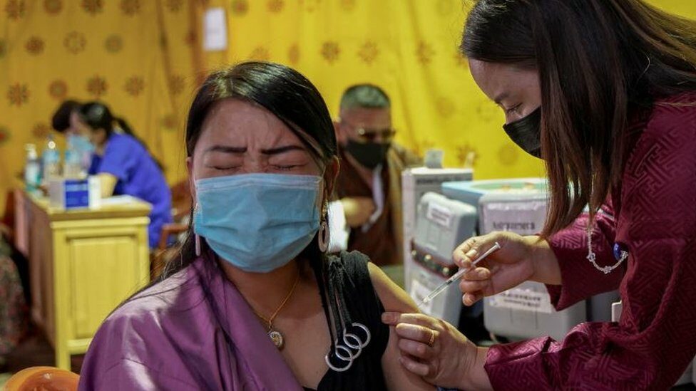 A health worker inoculates a woman at a temporary vaccination centre in Thimpu, Bhutan, on July 26