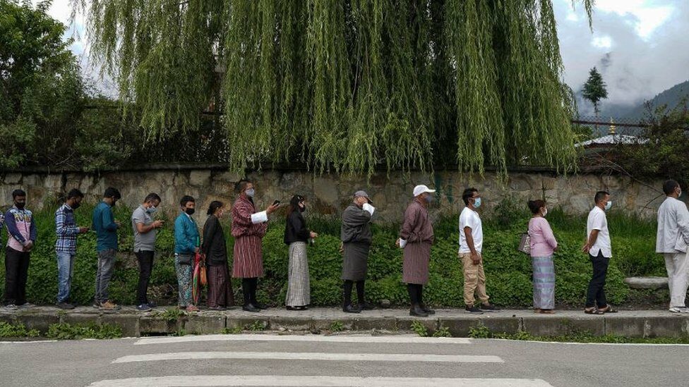 People queue up to register themselves and get inoculated with the Covid-19 coronavirus vaccine at a temporary vaccination centre in Thimpu
