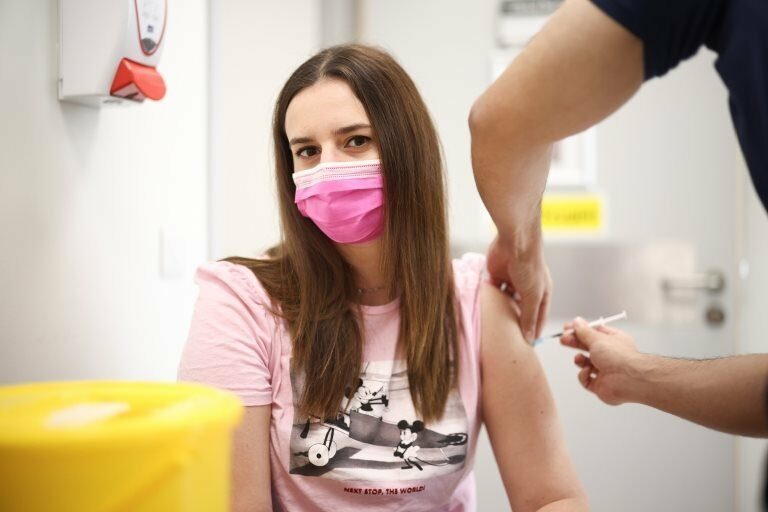 A person receives a dose of the Pfizer BioNTech vaccine at the Central Middlesex Hospital in London, Britain, August 1, 2021.