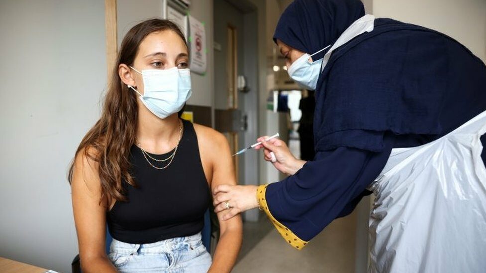 Nurse administers vaccine jab to a young person at Central Middlesex Hospital in London, August 1st 2021