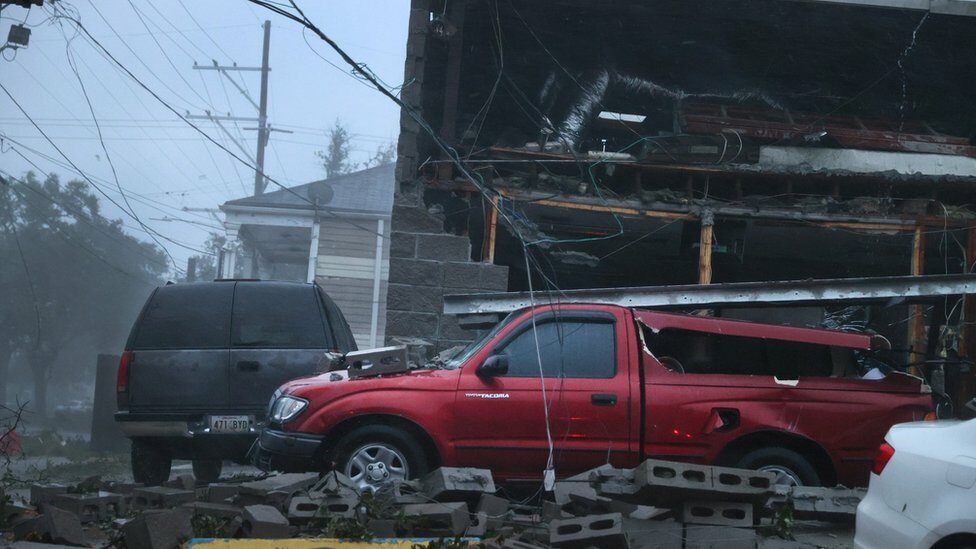 Vehicles damaged by collapsed building in New Orleans as Hurricane Ida makes landfall.