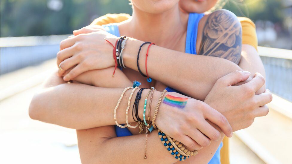 Two women embrace