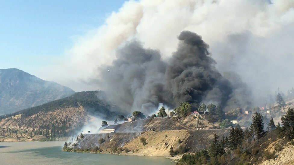 A view of Lytton burning from across the Fraser River