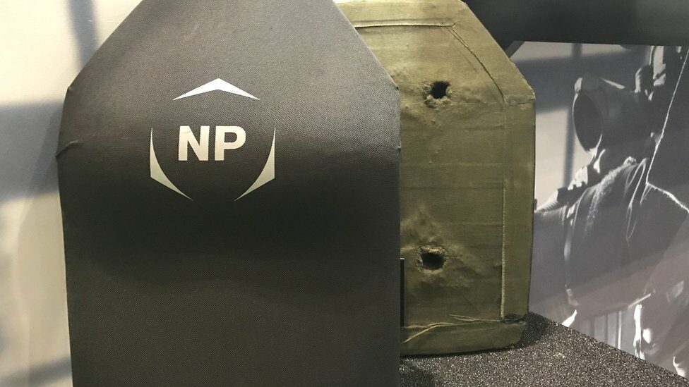 Protective plates, one with bullet holes