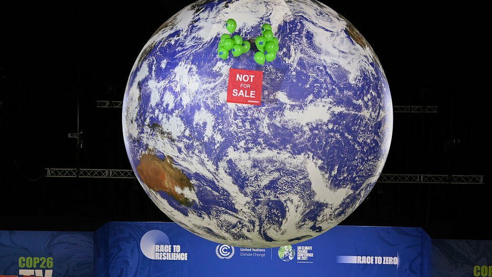 model of planet earth reading not for sale at COP26 summit