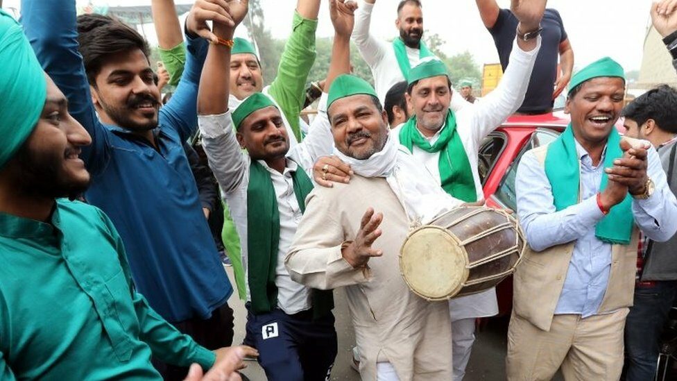 Indian farmers celebrate at the protest site at the Delhi Uttar Pradesh Boarder, India, 19 November 2021.