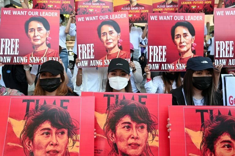Demonstrators hold up signs during a protest against the military coup and demanding the release of elected leader Aung San Suu Kyi, in Yangon, Myanmar, February 13, 2021