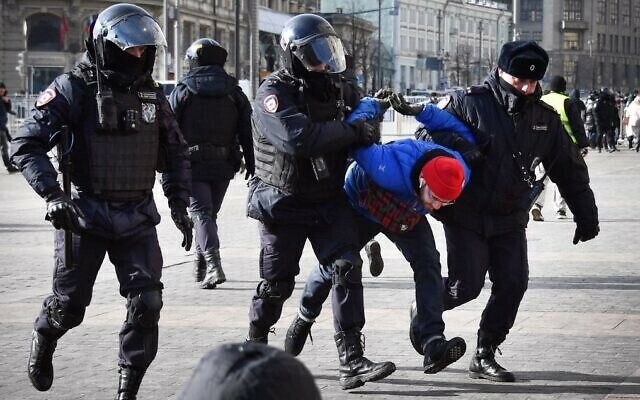 Police officers detain a man during a protest against Russia's invasion of Ukraine, in Manezhnaya square in central Moscow on March 13, 2022. (Photo by AFP)