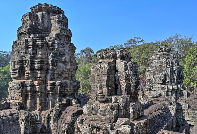 emerging behind a large tree Thousands of years old - built with Bayon Castle