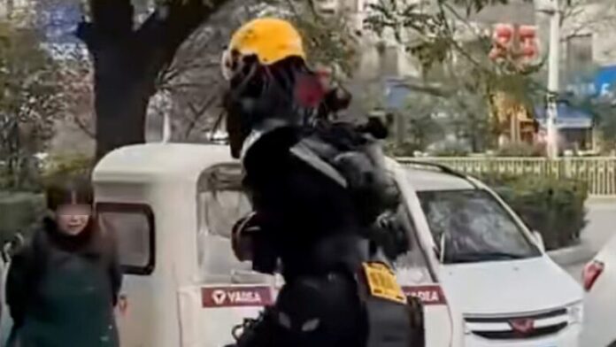 A perplexed woman looks on as Zhou runs past her on the street with a delivery. 