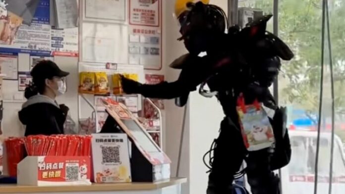 Zhou Gaosai picks up an order from a shop while kitted out in his mecha suit.