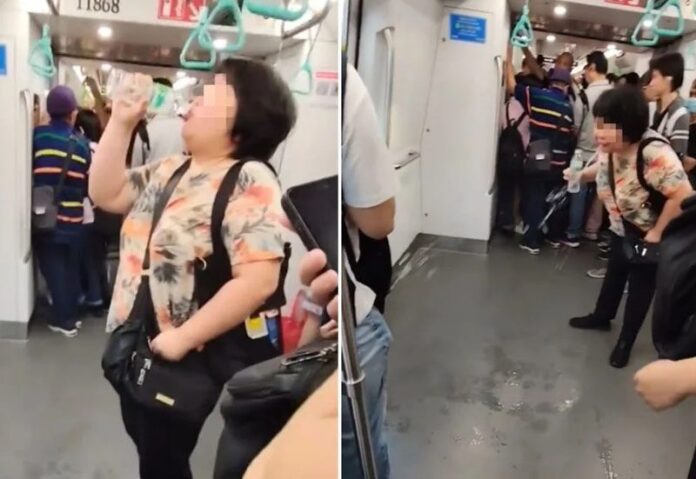 ป้ายืนพ่นน้ำบนรถไฟฟ้าสิงคโปร์ ไม่แคร์สายตา คนแน่นขบวน 