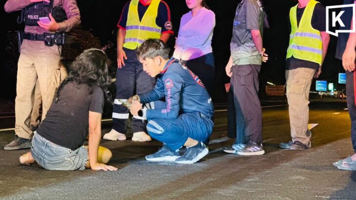 Drunk woman sits in road, narrowly avoids traffic hits